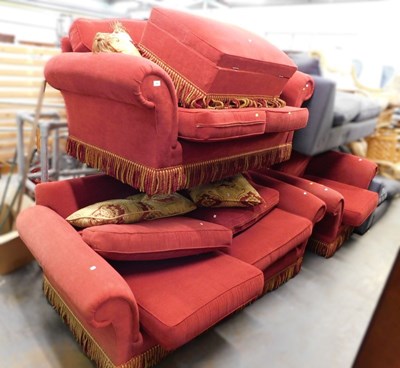 Lot 1680 - A red upholstered three seater sofa, with red...