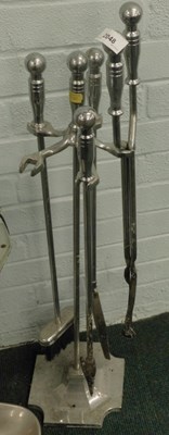 Lot 2048 - A cast aluminium fireside set, including brush,...