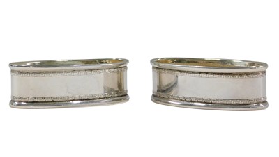 Lot 884 - A pair of Elizabeth II silver napkin rings, in...