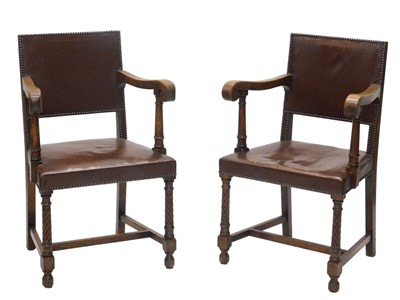 Lot 1058 - A pair of oak open armchairs, each with a...