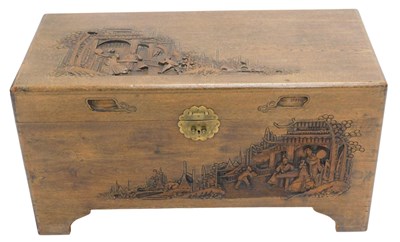 Lot 1059 - A carved Chinese camphorwood chest, decorated...