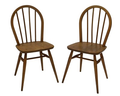 Lot 1026 - A pair of Ercol light coloured beech and elm...