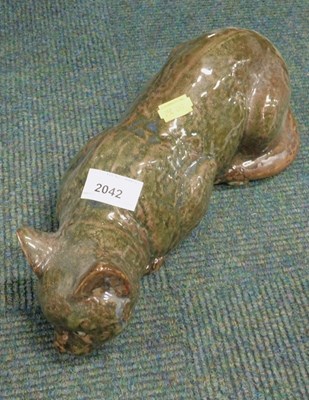 Lot 2042 - A ceramic cat, with green metallic glaze and...