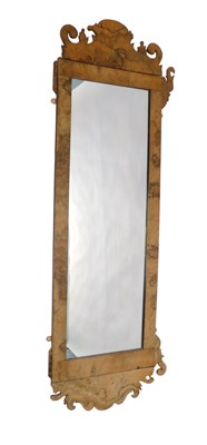 Lot 930 - A walnut fret framed wall mirror, with...
