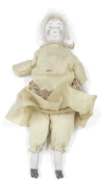 Lot 475a - An Eastern ceramic doll, in yellow silk dress,...