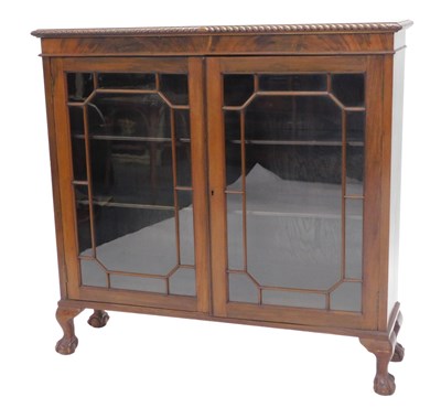 Lot 1074 - An early 20thC mahogany bookcase, the top with...