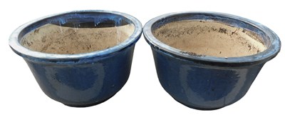 Lot 1080 - A large pair of blue glazed garden pots or...