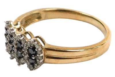 Lot 303 - A 9ct gold diamond and black diamond cluster...