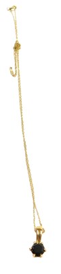 Lot 304 - A 9ct gold and black diamond solitaire pendant,...