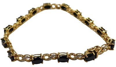 Lot 305 - A sapphire and diamond set figure of eight...