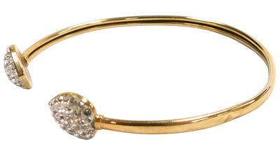 Lot 307 - A 9ct gold torc bangle, with heart-shaped...