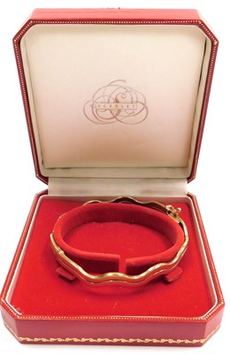 Lot 308 - A bi-colour wavy link bracelet, on a snap...