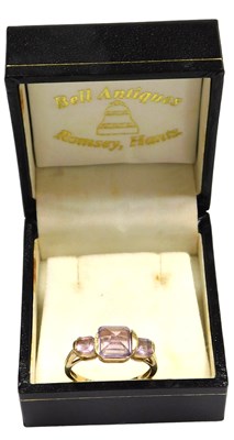Lot 309 - A 9ct gold and amethyst three stone ring, the...