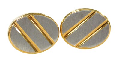 Lot 347 - A pair of bi-colour cufflinks, the oval table...