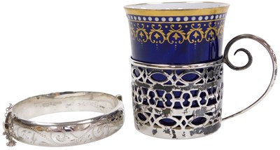 Lot 371 - A silver bangle, with engraved foliate...