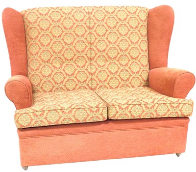 Lot 520 - A mid Century two seater wing back sofa,...