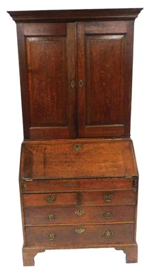 Lot 525 - A George III oak bureau bookcase, the outswept...