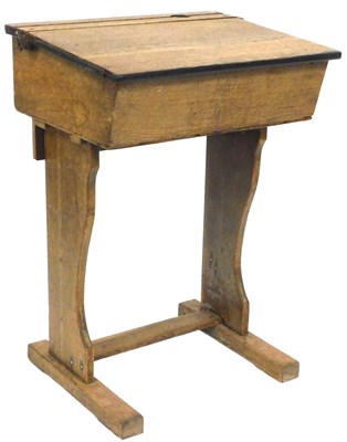 Lot 537 - An early 20thC oak school desk, the top with a...