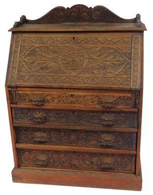 Lot 593 - A late Victorian oak bureau, with a foliate...