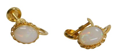 Lot 84 - A pair of opal earrings, each with oval opal...