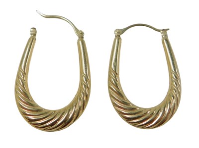 Lot 70 - A pair of hoop earrings, each of half twist...