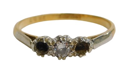 Lot 66 - A diamond three stone dress ring, set with a...