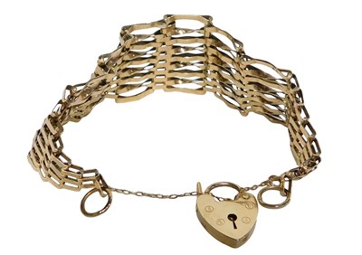 Lot 8 - A 9ct gold gate bracelet, of nine bar design,...