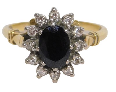 Lot 7 - An 18ct gold sapphire and diamond cluster ring,...