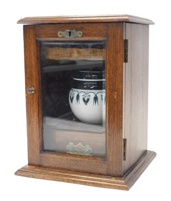 Lot 305 - An Edwardian oak smoker's cabinet, the top...