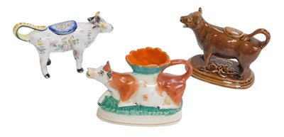 Lot 347 - Three Victorian and later pottery cow creamers,...