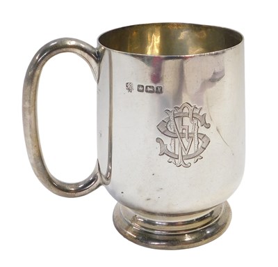Lot 154 - A George V silver mug, bearing initials, and...