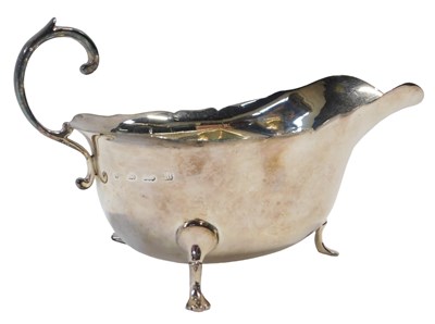 Lot 159 - A George V silver sauce boat, with piecrust...