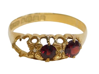 Lot 252 - An 18ct gold gypsy ring, set with two garnets...