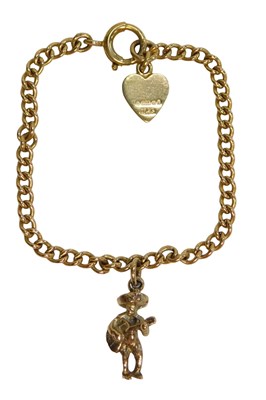 Lot 424 - A curb link bracelet, with two charms,...