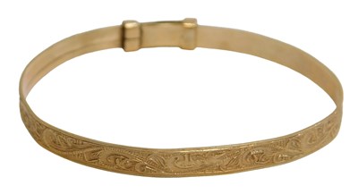 Lot 425 - A 9ct gold child's bangle, of heavy floral...