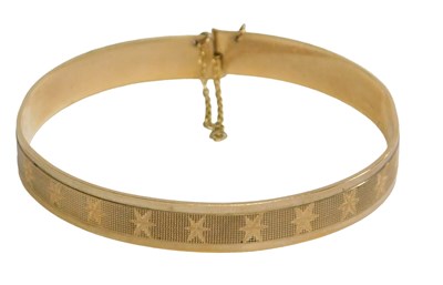 Lot 431 - A 9ct gold bangle, with crossover lock and...
