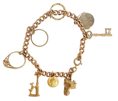 Lot 49 - A curb link charm bracelet, with eight...