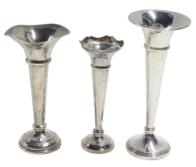 Lot 618 - Three Elizabeth II silver trumpet vases, each...