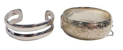 Lot 633 - A silver bangle, formed in two sections,...