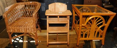 Lot 1042 - A bamboo side table with a glass top and a...