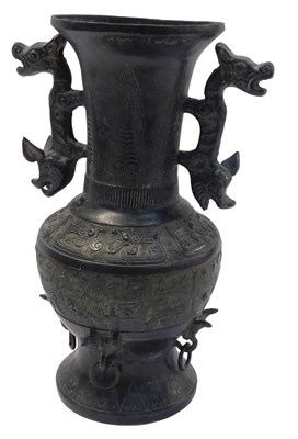 Lot 735 - An Oriental style cast metal twin-handled vase,...