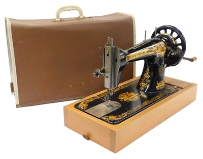 Lot 760 - A Singer hand operated cased sewing machine,...