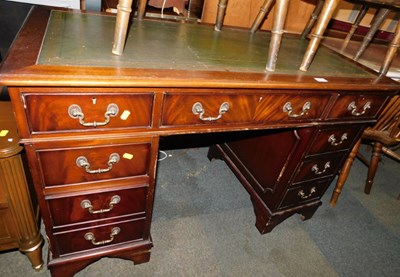Lot 1032 - A reproduction mahogany veneered pedestal desk,...
