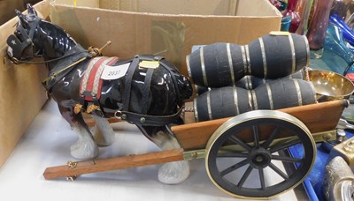 Lot 2037 - A ceramic horse with cart behind carrying...