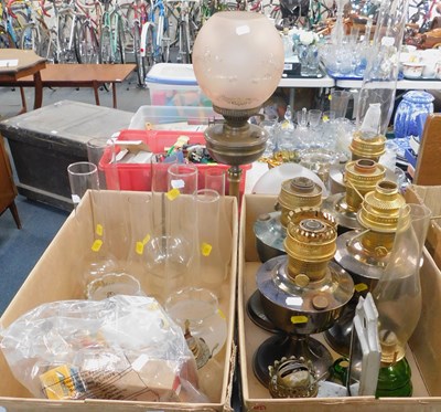 Lot 2039 - A group of oil lamps, chimneys and shades. (2...