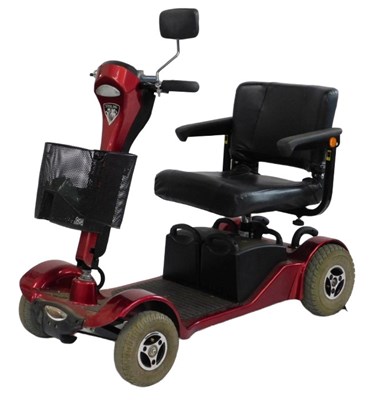 Lot 799 - A Sterling mobility scooter, in red trim, with...