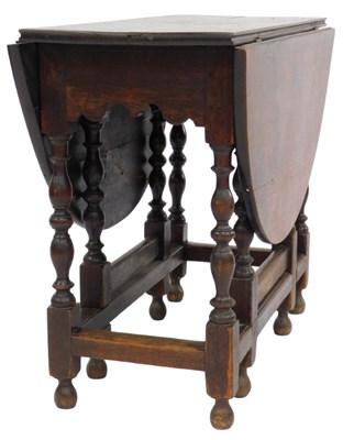 Lot 807 - An 18thC oak gate leg table, with a frieze...
