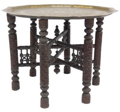 Lot 833 - An Indian brass tray top table, with engraved...