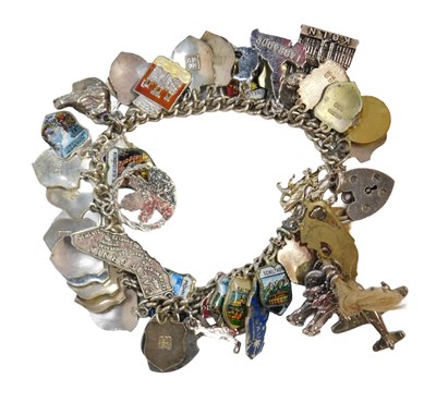 Lot 775 - A curb link bracelet, on a heart shaped...