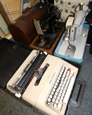 Lot 2149 - A hand-cranked Singer sewing machine, an...